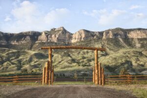 Ranch gate and cliffs in Wyoming, USA